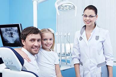 Hygienist and family at a dental cleaning appointment