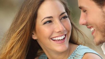 Man and woman smiling with white teeth